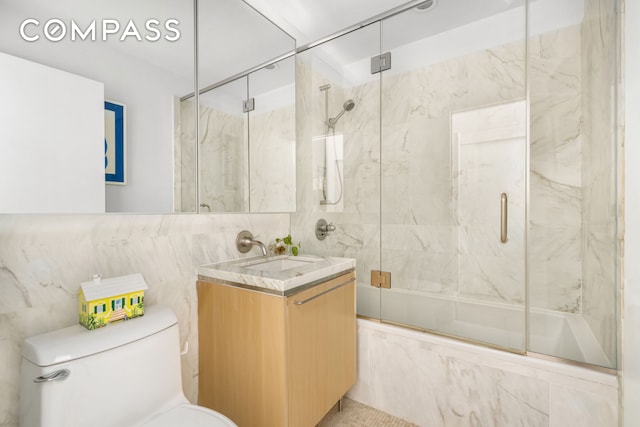 200 Chambers St Unit 25F, New York City, NY 10007 - bathroom featuring tile walls, toilet, bath / shower combo with glass door, and vanity