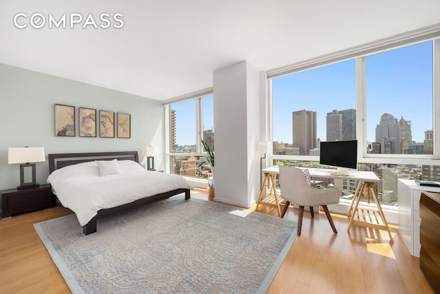 200 Chambers St Unit 25F, New York City, NY 10007 - bedroom featuring light wood finished floors, an office area, and a wall of windows