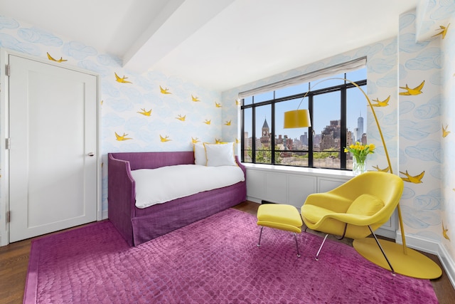 130 W 12th St Unit 9A, New York City, NY 10011 - bedroom with wallpapered walls, wood finished floors, a skyline view, and beam ceiling
