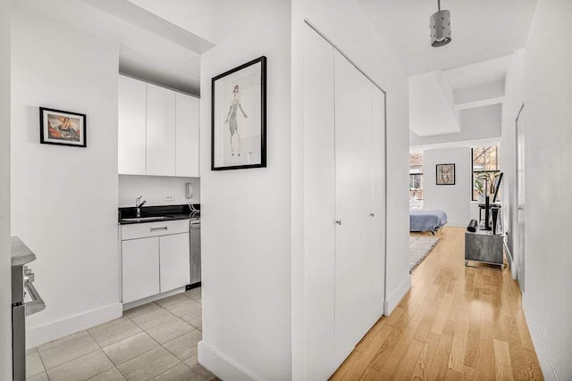 99 John St Unit 1011, New York City, NY 10038 - corridor with a sink, baseboards, and light wood-type flooring