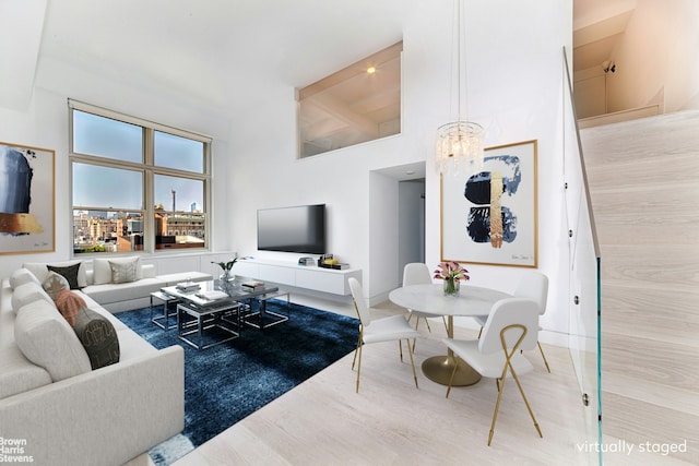 120 E 87th St Unit R14F, New York City, NY 10128 - living room with high vaulted ceiling, wood finished floors, a chandelier, and beam ceiling