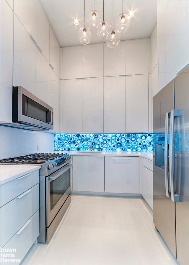 120 E 87th St Unit R14F, New York City, NY 10128 - kitchen featuring stainless steel appliances, modern cabinets, light countertops, and pendant lighting
