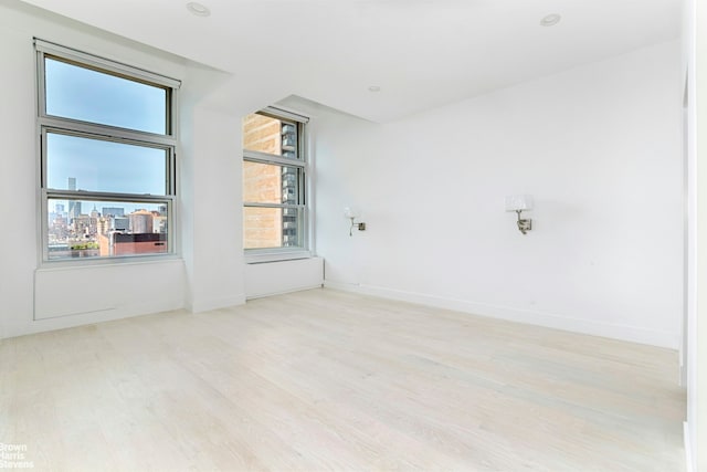 120 E 87th St Unit R14F, New York City, NY 10128 - unfurnished room with wood finished floors and baseboards