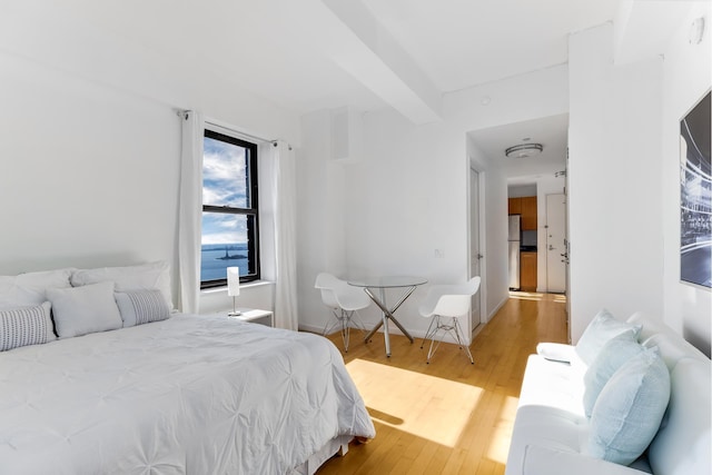 20 W St Unit 44C, New York City, NY 10004 - bedroom featuring freestanding refrigerator and wood finished floors