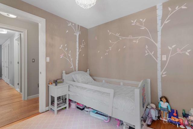 330 E 38th St Unit 8Ij, New York City, NY 10016 - bedroom featuring wood finished floors, baseboards, and a chandelier