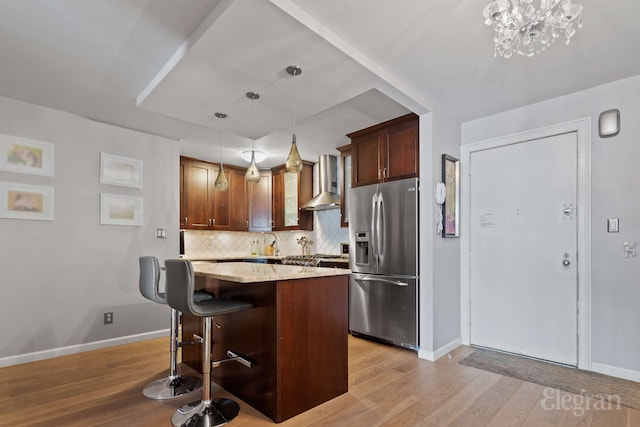 330 E 38th St Unit 8Ij, New York City, NY 10016 - kitchen with stainless steel fridge with ice dispenser, wall chimney exhaust hood, baseboards, light wood-style floors, and decorative backsplash