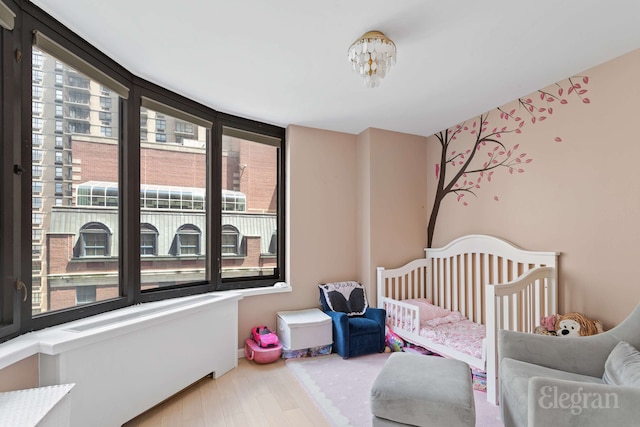 330 E 38th St Unit 8Ij, New York City, NY 10016 - bedroom with wood finished floors and a nursery area