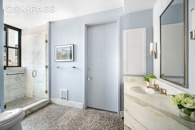 130 W 30th St Unit 16A, New York City, NY 10001 - full bathroom featuring a marble finish shower, vanity, toilet, and baseboards