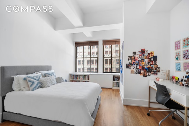 130 W 30th St Unit 16A, New York City, NY 10001 - bedroom featuring light wood finished floors, a desk, and beamed ceiling