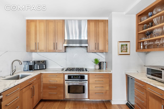 130 W 30th St Unit 16A, New York City, NY 10001 - kitchen featuring stainless steel appliances, wall chimney exhaust hood, beverage cooler, tasteful backsplash, and light stone countertops