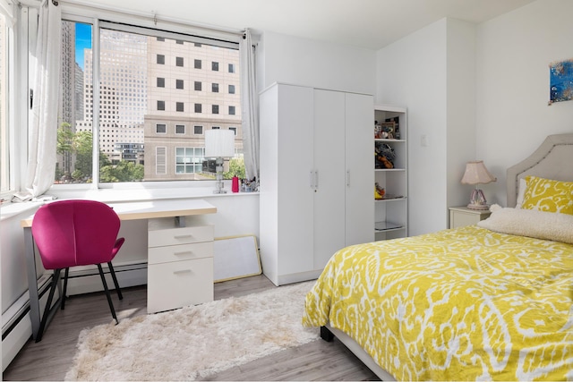 250 S End Ave Unit 3B, New York City, NY 10280 - bedroom with multiple windows, wood finished floors, a closet, and an office area