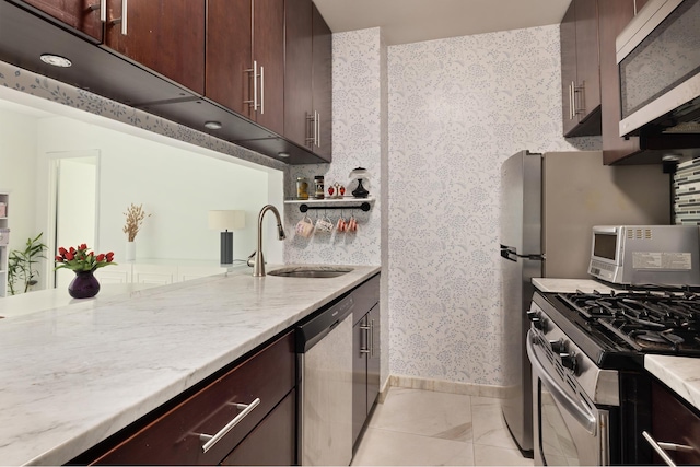 250 S End Ave Unit 3B, New York City, NY 10280 - kitchen with appliances with stainless steel finishes, wallpapered walls, a sink, baseboards, and light stone counters