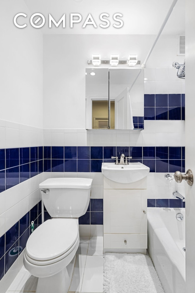 66 Madison Ave Unit 1D, New York City, NY 10016 - bathroom featuring tile walls, vanity, and shower / tub combination