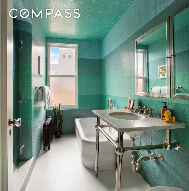 170 2nd Ave Unit 6B, New York City, NY 10003 - ensuite bathroom featuring a tub, a sink, and tile patterned floors