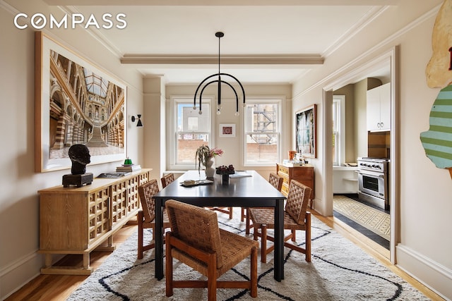 170 2nd Ave Unit 6B, New York City, NY 10003 - dining area with light wood finished floors, crown molding, baseboards, and a chandelier