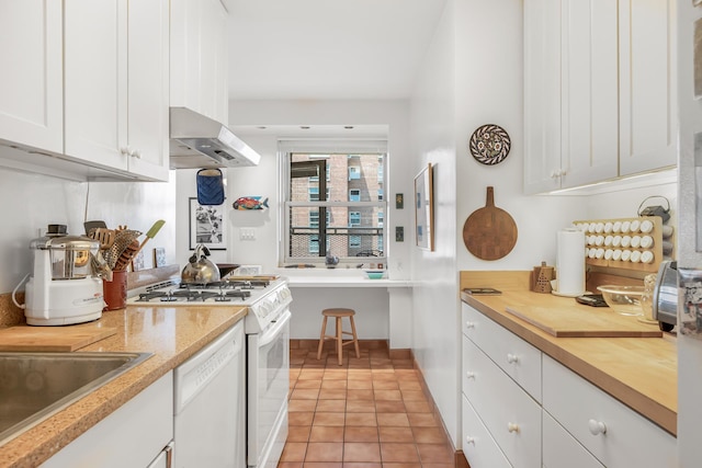 80 La Salle St Unit 18A, New York City, NY 10027 - kitchen featuring ventilation hood, white appliances, white cabinets, and light tile patterned floors