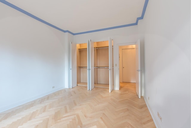 205 E 63rd St Unit 12C, New York City, NY 10065 - unfurnished bedroom featuring two closets and crown molding