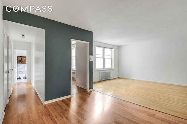 9801 Shore Rd Unit 4P, New York City, NY 11209 - spare room with radiator heating unit and wood finished floors