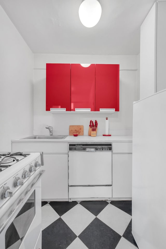 11 E 87th St Unit 9F, New York City, NY 10128 - kitchen featuring white appliances, tile patterned floors, a sink, and white cabinetry