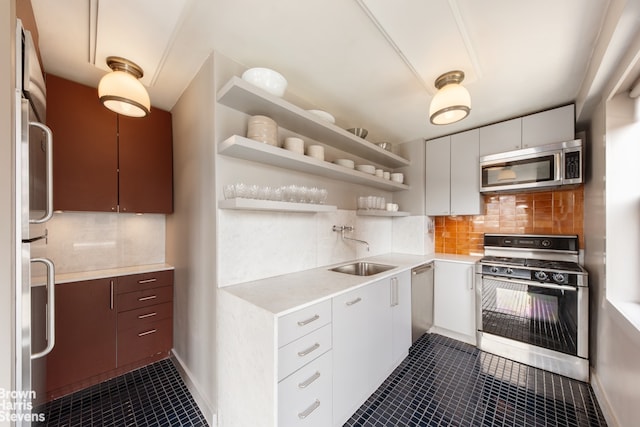 330 3rd Ave Unit 18B, New York City, NY 10010 - kitchen featuring stainless steel appliances, dark tile patterned flooring, open shelves, light countertops, and backsplash
