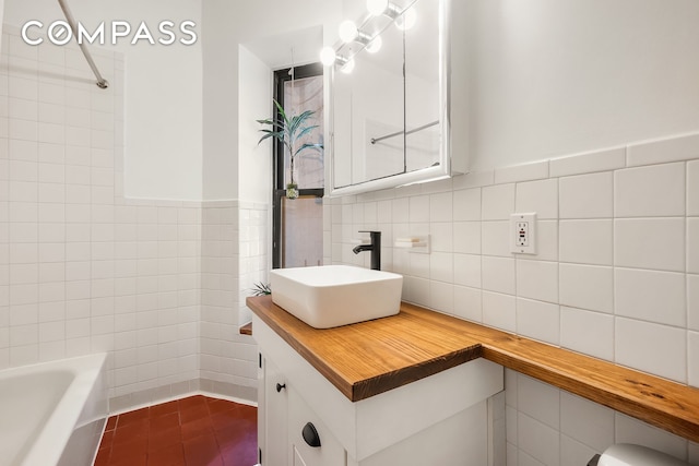 41 Perry St Unit 2A, New York City, NY 10014 - bathroom featuring tile walls, vanity, tile patterned floors, and a wainscoted wall