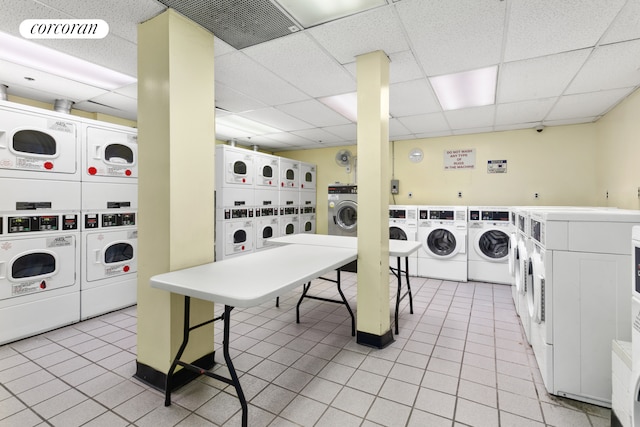 140 W 69th St Unit 26C, New York City, NY 10023 - shared laundry featuring stacked washer and clothes dryer, separate washer and dryer, and light tile patterned floors