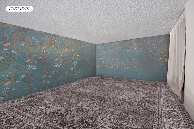 140 W 69th St Unit 26C, New York City, NY 10023 - carpeted spare room featuring wallpapered walls and a textured ceiling