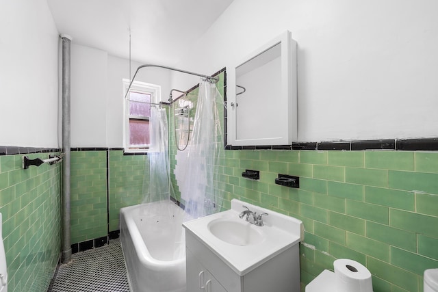 41-25 44th St Unit C5, New York City, NY 11104 - full bath featuring tile walls, vanity, shower / bath combo with shower curtain, wainscoting, and tile patterned flooring