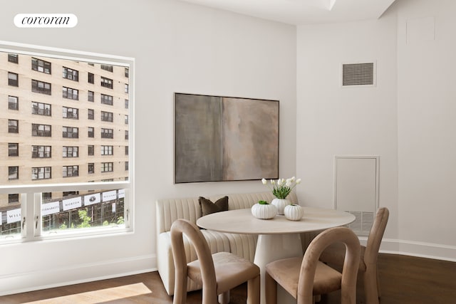 250 E 49th St Unit 3D, New York City, NY 10017 - dining room featuring baseboards and dark wood-style floors