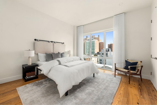427 E 90th St Unit Penthouse9, New York City, NY 10128 - bedroom featuring access to exterior, a view of city, and light wood-style flooring