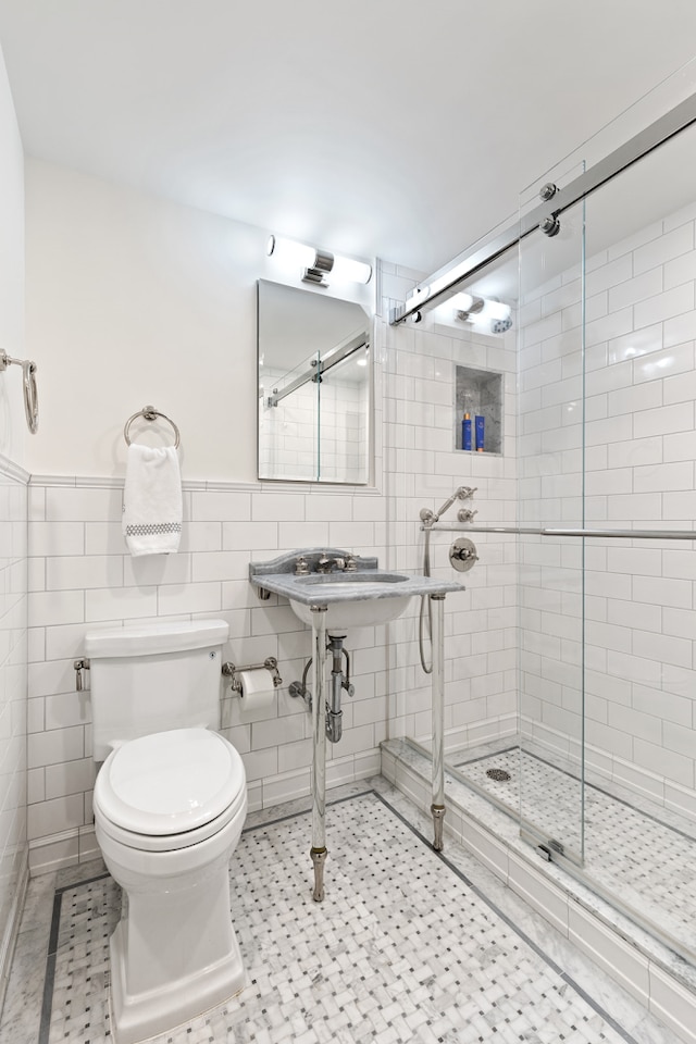 430 E 56th St Unit 11B, New York City, NY 10022 - full bathroom featuring a shower stall, tile walls, and wainscoting
