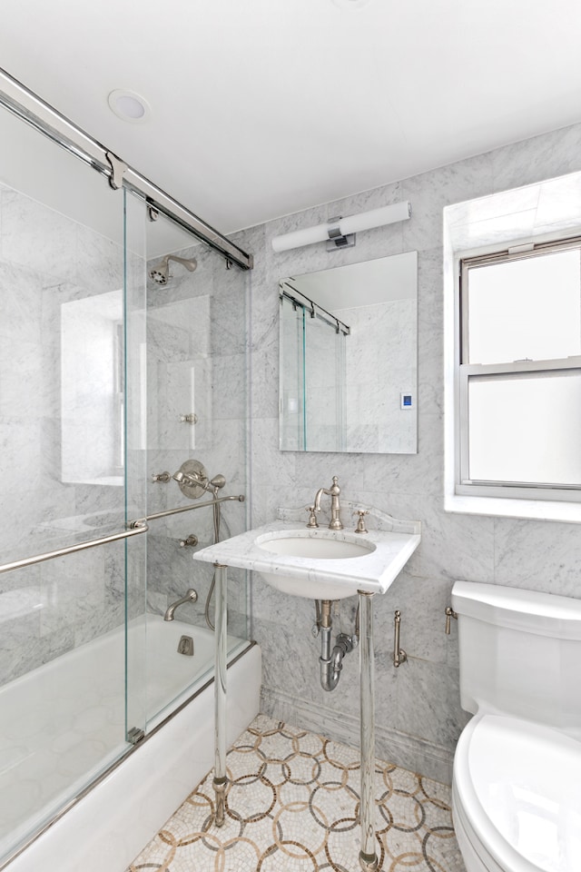 430 E 56th St Unit 11B, New York City, NY 10022 - bathroom featuring shower / bath combination with glass door and tile walls