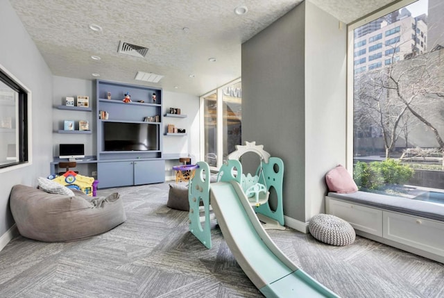 845 United Nations Plz Unit 11-C, New York City, NY 10017 - rec room with a textured ceiling, recessed lighting, and carpet flooring