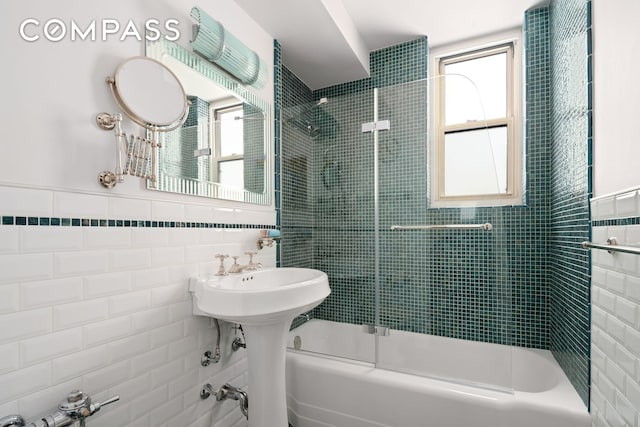 63 E 9th St Unit 4U, New York City, NY 10003 - bathroom with tile walls and combined bath / shower with glass door