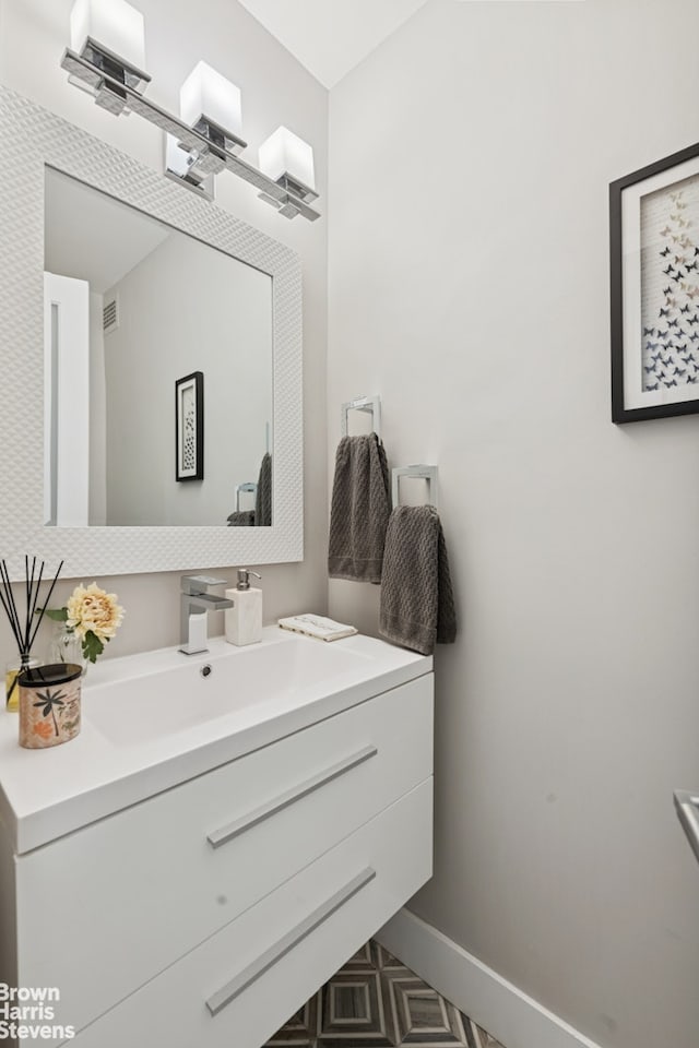 303 E 57th St Unit 14G, New York City, NY 10022 - bathroom featuring vanity and baseboards