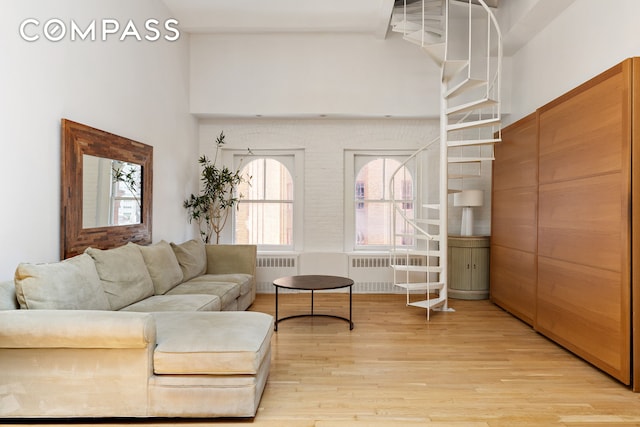 55 Hudson St Phe, Phe, New York City, NY 10013 - living area with radiator, light wood-style floors, and a towering ceiling