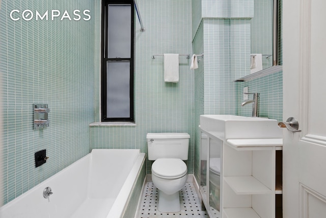 223 W 21st St Unit 1M, New York City, NY 10011 - bathroom with a garden tub, tile walls, and tile patterned floors