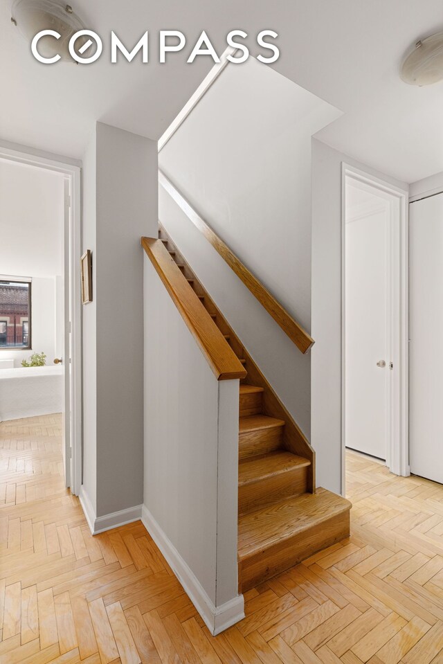 393 W 49th St Unit 5C, New York City, NY 10019 - stairs featuring baseboards