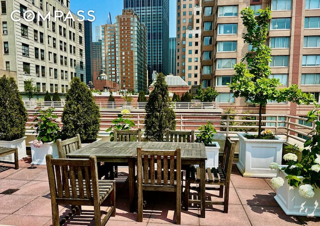 393 W 49th St Unit 5C, New York City, NY 10019 - view of patio / terrace with outdoor dining space and a city view