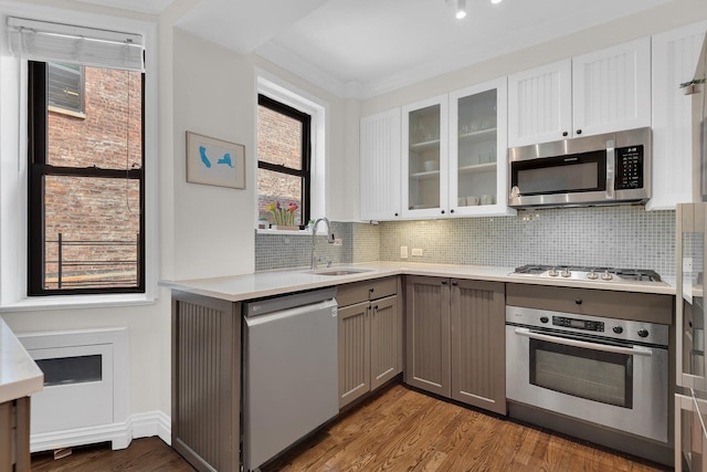 160 W 85th St Unit 5H, New York City, NY 10024 - kitchen featuring stainless steel appliances, gray cabinets, light countertops, wood finished floors, and tasteful backsplash