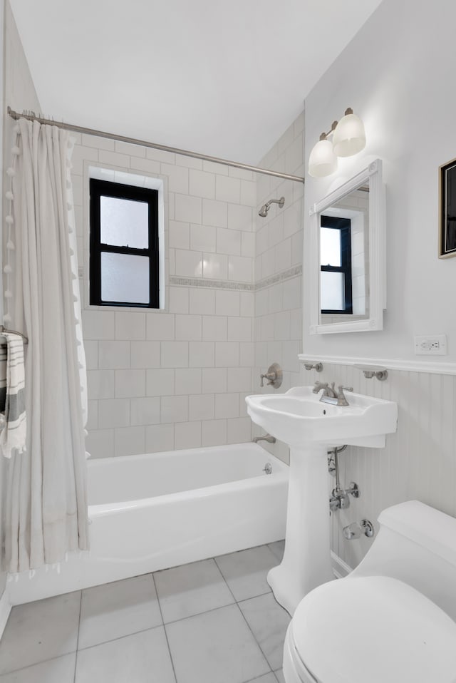 160 W 85th St Unit 5H, New York City, NY 10024 - bathroom featuring shower / bath combo with shower curtain, tile patterned flooring, plenty of natural light, and a wainscoted wall