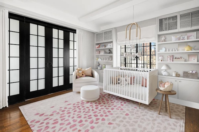 227 E 57th St Unit 12Eg, New York City, NY 10022 - bedroom with wood finished floors, french doors, and a nursery area