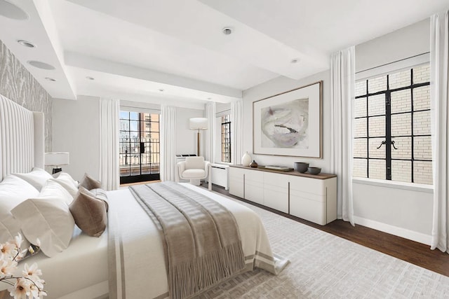 227 E 57th St Unit 12Eg, New York City, NY 10022 - bedroom featuring baseboards and wood finished floors