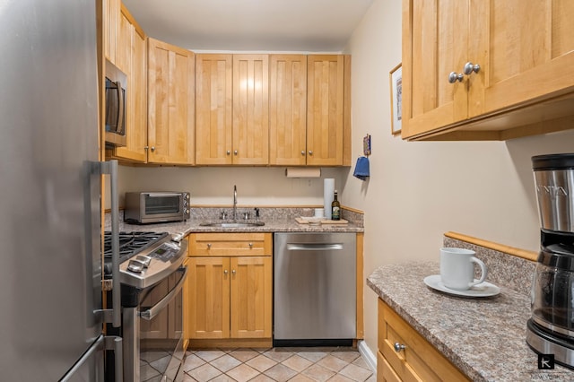222 E 80th St Unit 6-C, New York City, NY 10075 - kitchen featuring appliances with stainless steel finishes, light stone counters, and light tile patterned floors