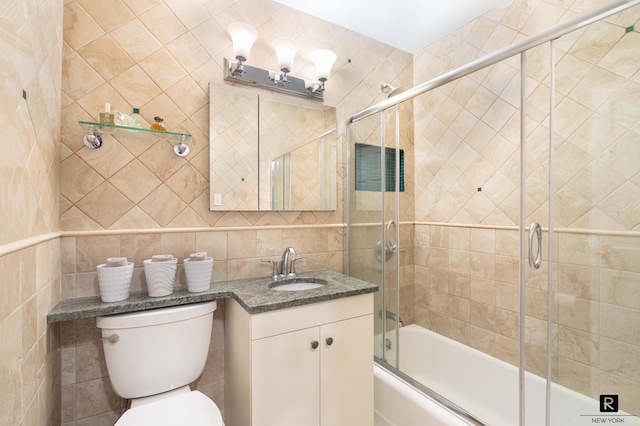 222 E 80th St Unit 6-C, New York City, NY 10075 - bathroom featuring tile walls, vanity, and bath / shower combo with glass door