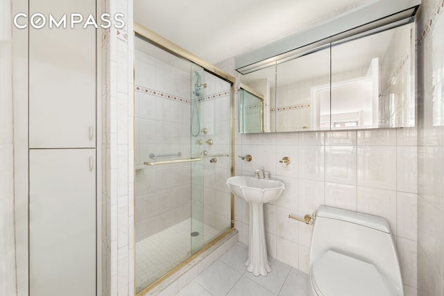 45 Sutton Pl S Unit 14N, New York City, NY 10022 - full bathroom with tile patterned floors, a stall shower, and tile walls