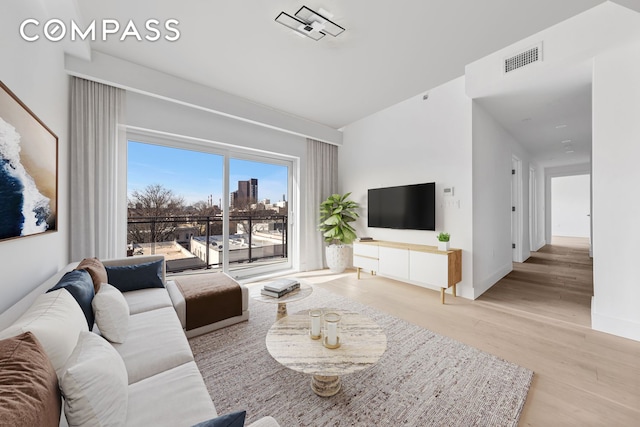 12-16 30th Ave Unit 201, New York City, NY 11102 - living area featuring wood finished floors and baseboards