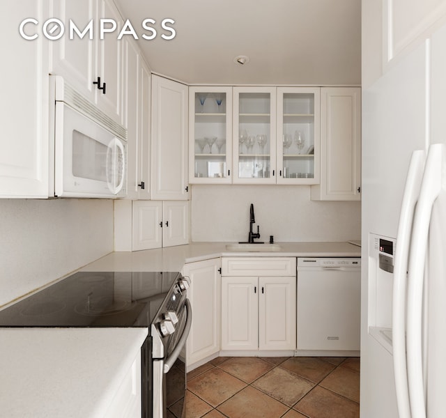 475 Park Ave Unit 3C, New York City, NY 10022 - kitchen featuring white appliances and white cabinets
