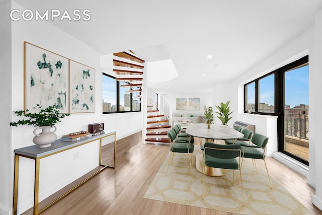 136 E Broadway Pha, Pha, New York City, NY 10002 - dining room featuring plenty of natural light, wood finished floors, stairs, recessed lighting, and a city view