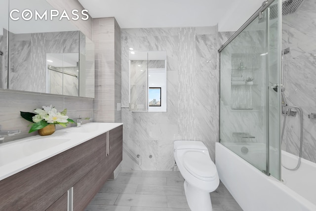 136 E Broadway Pha, Pha, New York City, NY 10002 - bathroom featuring tile walls, combined bath / shower with glass door, and double vanity